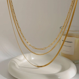 Layered gold titanium steel necklace set featuring snake and paperclip chain styles