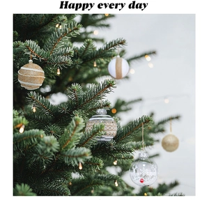 Detail of elegant gold and ivory Christmas tree hanging ornaments with warm light ambiance