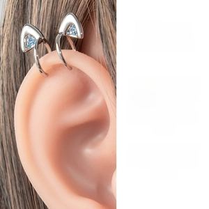 Detailed macro view of silver cat ear cuff featuring micro-set blue zircon stones