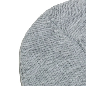 Macro view of grey knitted fabric with detailed spiral pattern and warm texture