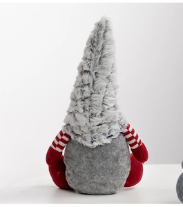Close-up of a Christmas gnome featuring a long grey plush hat and red striped arms
