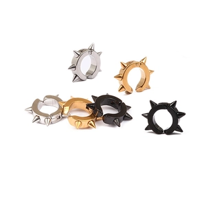 Detailed macro view of punk style spike ear clips in silver, gold, and black finish