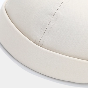 Close-up of beige quick-dry skull cap showing premium ripstop checkered fabric texture