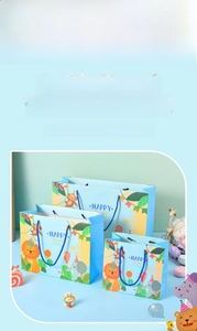 Three sizes of light blue gift bags with cartoon animals and woven rope handles