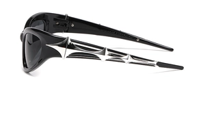 Close-up of Y2K cyberpunk sunglasses with silver star details on black frames