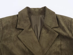 Detail of dark olive green faux suede texture and lapel stitching on the blazer