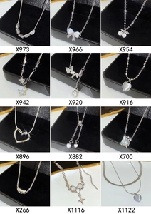 Detailed catalog of silver titanium necklaces with butterfly, pearl and heart pendants