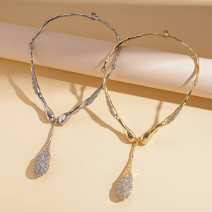 Retro aesthetic liquid metal necklaces in gold and silver with teardrop rhinestones
