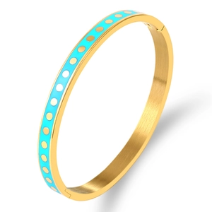 Detailed macro of gold-plated stainless steel bangle with sky blue enamel and polka dots