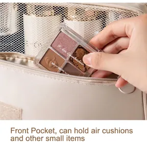 Hanging travel cosmetic bag in beige featuring front pocket for eyeshadow palette