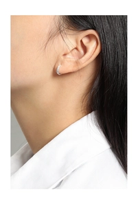 Close-up of a minimalist S925 sterling silver hoop earring with fine stones on a model