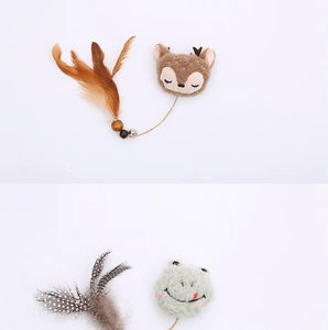 Detail of plush cat toys with deer and frog designs featuring feathers and bells