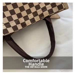 Detail of reinforced woven handles on a retro checkered linen tote bag for women