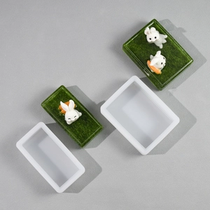 Detailed rectangular silicone mold showing rabbit resin craft inside translucent resin blocks