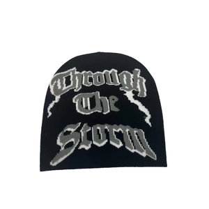 Double-sided jacquard knit beanie with Through the Storm gothic lettering for winter warmth