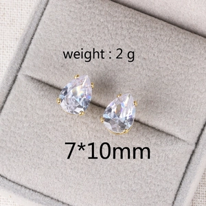 Close-up of 7x10mm teardrop zircon earrings in gold setting weighing 2g each