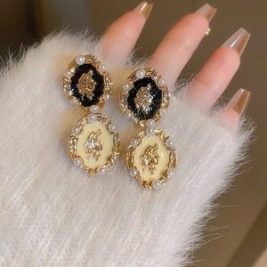 Vintage French baroque pearl earrings with relief portrait motifs in black and cream gold