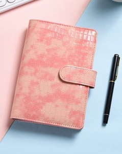 Detail of pink crocodile texture PU leather A6 binder cover with magnetic buckle closure