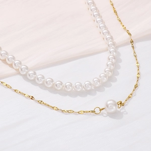 Close-up of double-layer necklace with white pearls and gold titanium steel chain