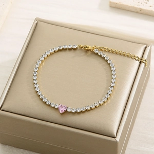 Detail of pink heart tennis bracelet with gold chain and zircon inlay on jewelry box