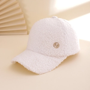 White sherpa fleece baseball cap with gold M logo on a stylish pleated background