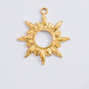 Macro detail of 18k gold plated sunburst pendant charm with polished metallic finish