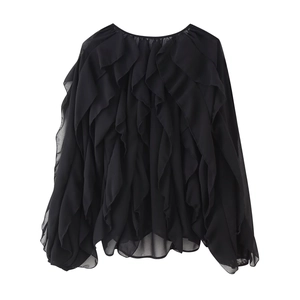 Detail of layered black chiffon ruffles and semi-transparent texture on long sleeve shirt