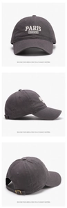 Detail view of washed cotton baseball cap with white Paris French embroidery and metal buckle