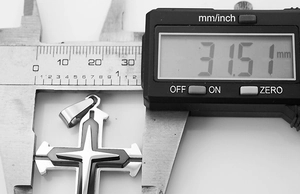 Detailed measurement of the triple-layer cross pendant showing 31.51 mm width on a caliper