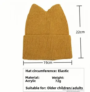 Detail of yellow knit cat-ear beanie made of acrylic fabric with size specifications