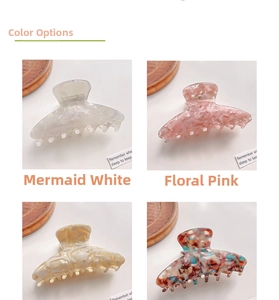 Detailed view of four acetate hair claw clips in marble, floral, and tortoiseshell patterns