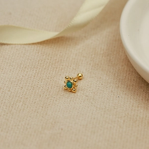 Detail of vintage gold flower cartilage earring with turquoise stone and ball screw back