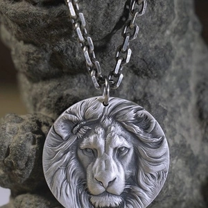 Mens vintage lion head medallion pendant necklace on Cuban chain with a stone backdrop