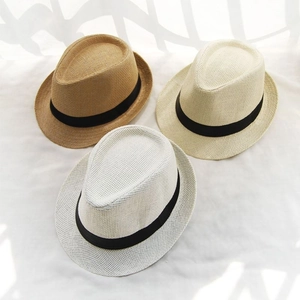 Detailed top view of straw trilby hats in white, beige, and khaki with black ribbons