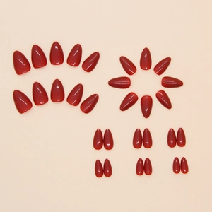 Glossy burgundy almond-shaped press-on nails set in various sizes on a beige background