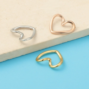 Detailed view of cutout heart rings in silver, gold, and rose gold stainless steel finishes