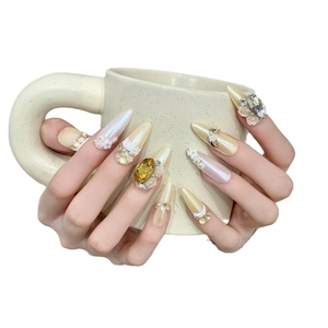 Luxury handmade press-on nails with golden accents, pearls and large yellow diamonds