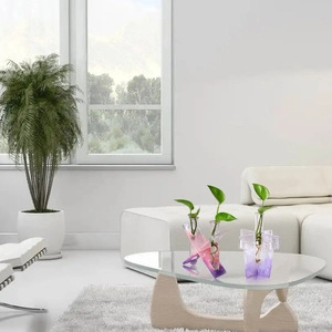 Creative gradient pink and purple hydroponic glass test tube vases on a modern table