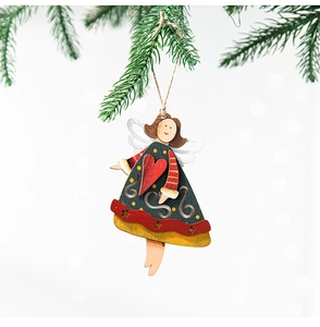 Close-up of wooden angel ornament with hand-painted details hanging on a Christmas tree