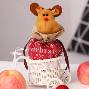 Christmas reindeer drawstring gift bag with Celebrate text inside a white woven basket