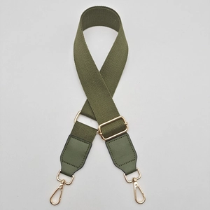Close-up of army green adjustable nylon strap with gold metal hooks for handbags