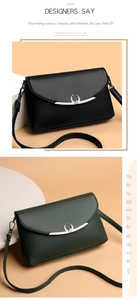 Close-up of black and dark green lychee grain leather crossbody bags with silver heart buckles