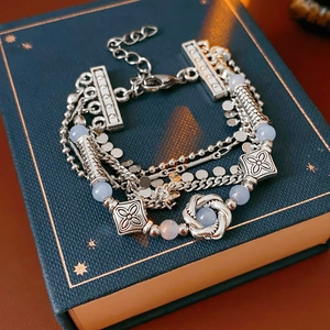 Detail of multi-layer vintage silver bracelet with light blue beads on blue gift box