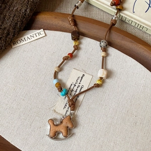Handmade Bohemian necklace with wooden rocking horse pendant and colorful beads