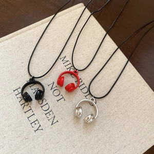 Detailed view of headphone pendants in black, red, and silver on minimalist cord necklaces