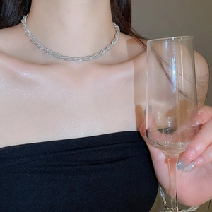 Silver twisted rope necklace close-up on model for elegant evening party styling