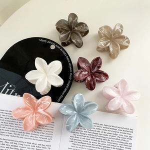 Floral hair claw clips in marble texture cream colors and five-petal flower design