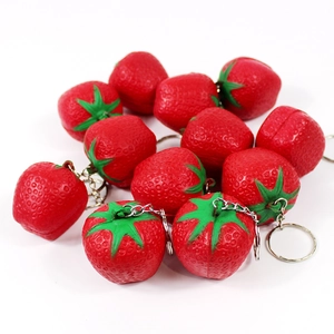 Close-up of 12 realistic red strawberry fruit keychains with metal chains on white background