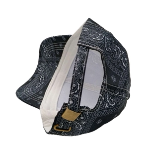 Detail of adjustable metal buckle and paisley pattern on street style baseball cap