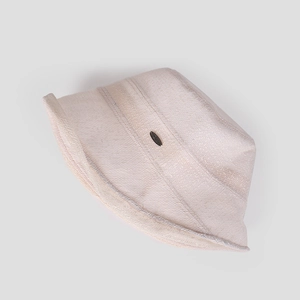 Close-up of beige breathable knit bucket hat with a stylish oval metal buckle accent